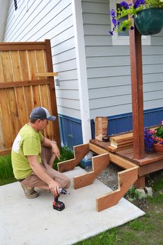 a man is working on some steps in the yard with his drill and screwdriver