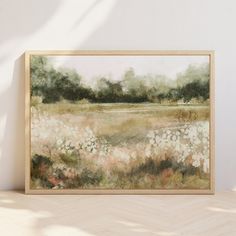 a painting hanging on the wall next to a wooden frame with an image of flowers in it