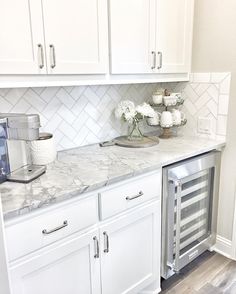 a kitchen with white cabinets and marble counter tops is featured in the magazine butter'n pantry