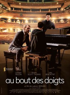 two men sitting at a piano in front of an auditorium with the caption au bout des doits