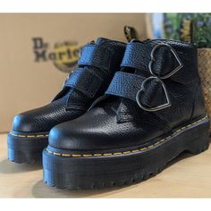 Doc Martens Devon Heart Leather Platform Boots Color: Black Milled Nappa Size: Women's 6 / Uk 4 / Eu 37 New In Box W/O Lid From Dr. Martens: * These Devon Heart Boots Sit On A Towering 1 7/8 Inch Quad Retro Platform Sole * Decked Out With Two Straps Woven And Standout Heart-Shaped Buckles * Built From Fine-Grained Milled Nappa, A Hardwearing Pebbled Leather That Feels Soft And Supple From The First Wear * Padded Tongue And Quarters For Additional Comfort * Goodyear-Welted Lines Are Heat-Sealed A Doc Martens Heart, Doc Martens Devon, Dr Martens Devon Heart, Heart Boots, Dr Martens Style, Leather Platform Boots, Black Leather Combat Boots, Martens Style, Dr Martens Womens