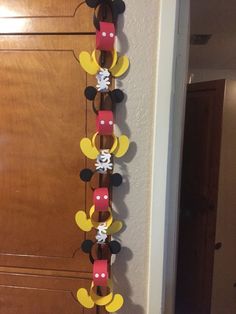 a mickey mouse birthday decoration hanging from the side of a wall in front of a door