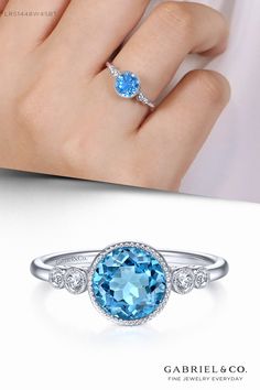 A bright blue hued topaz center stone is the colorful focal point of this classic fashion ring. The December birthstone is flanked by bezel set round diamonds adding 0.06cts of sparkle to this 14K white gold bauble. LR51448W45BT #14KWhiteGold#DiamondRing#BlueTopaz #GabrielNY#UniqueJewelry #FineJewelry#GabrielAndCo #FineJewelry#FashionJewelry#UniqueJewelry #GiftIdeas#DiamondJewelry#Jewelry#gabrieljewelry #Gifts #Jewelry #Design#HandcraftedJewelry #Elegance #LadiesRing#FashionLadiesRing#GoldRing Topaz And Diamond Ring, Ladies Rings, Gemstones Jewelry, Gifts Jewelry, Fashion Ring, December Birthstone, Classic Fashion, Contemporary Jewelry, Birthstone Jewelry