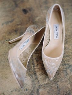 two pairs of wedding shoes sitting on top of a table