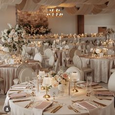 the tables are set with white and gold linens for an elegant wedding reception,