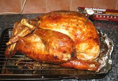 a roasted turkey sitting on top of a grill