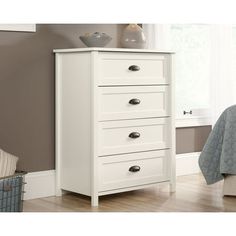 a white chest of drawers in a bedroom