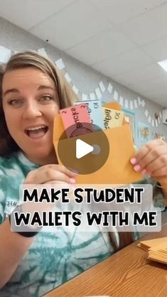 a woman sitting at a table holding up a piece of paper with the words make student wallets with me