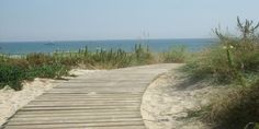 a wooden walkway leading to the beach