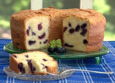 a blueberry pound cake on a plate with a slice cut out