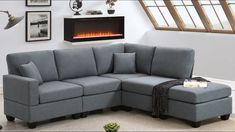 a living room with a blue sectional couch and an electric fireplace