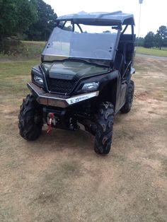 an off road vehicle parked in the dirt