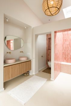 a bathroom with two sinks and a large mirror on the wall next to a bathtub