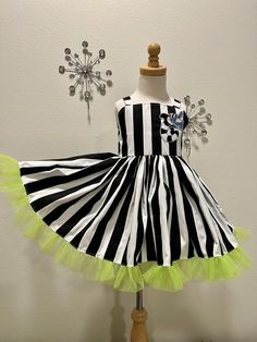 a black and white striped dress on a mannequin with lime green tulle