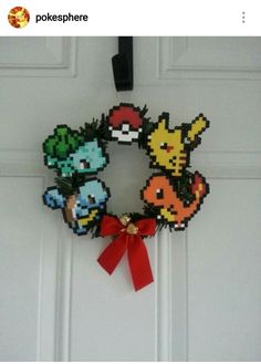 a wreath made out of pixelated video game characters hangs on the front door of a house