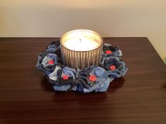 a candle sits on top of a wooden table