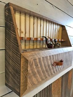 a wooden shelf with three pairs of shoes on it