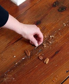 a person is peeling nuts on a wooden table