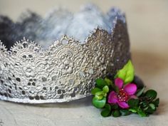 a silver crown with flowers on the side