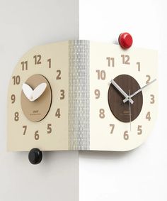 an unusual clock made out of wood and paper