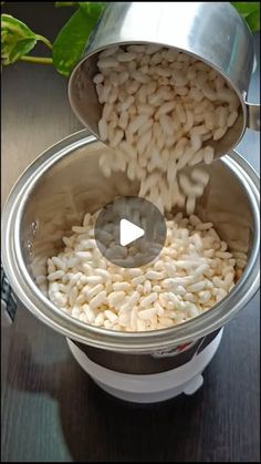 a pot filled with white beans on top of a wooden table