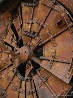 an old rusted metal wheel with rivets on it