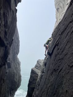 a man climbing up the side of a cliff