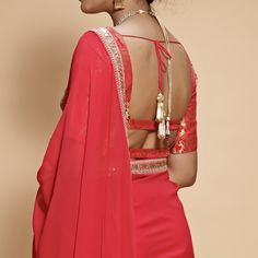 This set features a wide neck neck blouse tailored in rose red and gold brocade. It is teamed with a matching georgette sari with scallop, zari and dori borders and gold tassels at the palla. Includes Satin Underskirt Composition: Blouse: Brocade Silk, Sari : Viscose Georgette All products can be customised for sleeves, length of blouse and neck design Delivery : 2 weeks as the product is hand crafted. Check Size Guide or choose MySize for free customisation (All Sizes above XL can be made at 15% additional cost) For more information and sizes please contact fabiliciousfashion@gmail.com or visit our Copenhagen studio. About the Designer : Renee Label was created in 2013,by the talented sister duo Pooja and Karuna, is a culmination of their love for fashion and art. The mesmerizing wedding Elegant Blouse With Dupatta For Celebrations, Blouse With Sheer Dupatta For Celebrations, Celebration Blouse With Sheer Dupatta In Traditional Drape, Elegant Fitted Pre-draped Saree With Gota Work, Elegant Navratri Celebration Choli, Elegant Festive Blouse With Gota Work, Festive Celebration Blouse With Sheer Dupatta, Elegant Blouse For Eid Celebration, Elegant Fitted Blouse With Gota Work