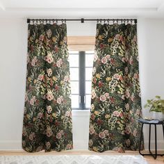 a bedroom with floral curtains and a white rug