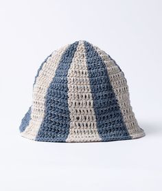 a crocheted hat with blue and white stripes on it, sitting against a white background