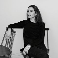 a black and white photo of a woman sitting on a chair