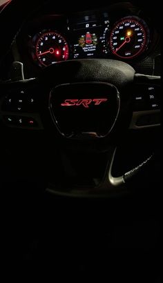 the interior of a car with dashboard lights and gauges lit up in the dark