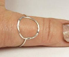 A hammered circle ring made with 18 gauge wire. Modern and simple minimal jewelry.Made with sterling silver Handmade and polished to a high shine in my shop.The circle symbol meaning is universal, sacred and divine. It represents the infinite nature of energy, and the inclusivity of the universe.Purity ring, karma ring,  midi ring modern and simpleIt's normal for sterling silver to change color to yellow or black due to oxidation after wear, just polish with warm water and a soft cloth, or use S Silver Hammered Minimalist Midi Rings, Hammered Sterling Silver Midi Rings, Minimalist Hammered Sterling Silver Midi Rings, Simple Hammered Rings, Silver Hammered Midi Rings, Hand Forged Sterling Silver Stackable Rings, Karma Ring, Silver Jewelry Cleaner, Circle Symbol