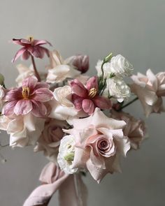 a vase filled with pink and white flowers