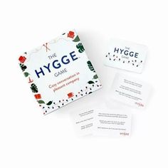 the hygge board game is shown with four cards and one card holder