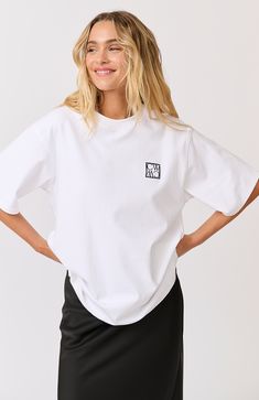 DESCRIPTION Stay effortlessly cool with the Sadie Tee in White by Cartel & Willow. This oversized t-shirt features a relaxed fit, making it the perfect go-to for casual, comfortable style. Made from high-quality cotton, it offers breathability and softness for all-day wear. The tee is accented with a minimalistic logo patch on the chest, adding a touch of brand flair without overpowering its simple design. Whether you're lounging at home or out and about, the Sadie Tee ensures you look chic and Embroidered Monogram, Slip Skirt, Minimalist Logo, Monogram Logo, Look Chic, Toffee, Comfortable Fashion, Favorite Jeans, Logo Embroidered