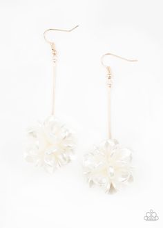 the white flower earrings are hanging from gold hooks