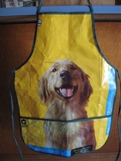 a yellow apron with a photo of a golden retriever on the front and side