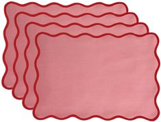 three pink placemats with scalloped edges