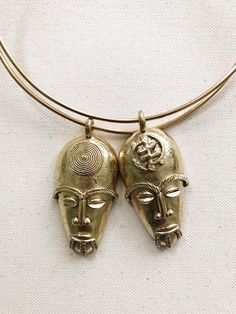 "A stunning 2.5\" bronze African Mask hand crafted in Ghana on a thick handmade brass choker. These mask features a detailed crown, perfect eyebrows and distinct facial features. Mask Size: 2.5\"L x 1.5\"W Choker length: 16\" Unisex *Ships with a polishing cloth to keep it forever shining. *Packaged for gift giving. *Sold individually. Return to shop: Afrohemien.etsy.com Like and Follow Afrohemien for updates, sales, coupons and surprise giveaways Instagram/Blog: instagram.com/Afrohemien Tumblr: Afrocentric Jewelry, Yeezy Fashion, African Skirts, Necklace African, Mask Necklace, African Mask, African Necklace, Wrist Jewelry, Perfect Eyebrows