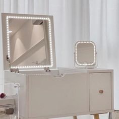 a vanity with a mirror and lights on it