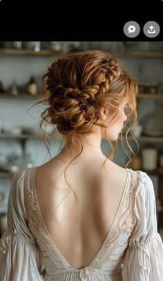 the back of a woman's head wearing a white dress