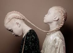 two women with braids standing next to each other