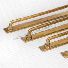 three brass drawer pulls on a white background with the words country hardware company written below them