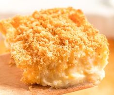 a close up of a piece of food on a cutting board with crumbs