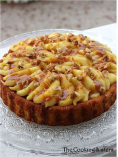 a cheesecake topped with macaroni and cheese on a glass plate