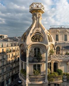 a clock tower in the middle of a building with balconies on it's sides