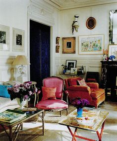 a living room filled with furniture and pictures on the wall