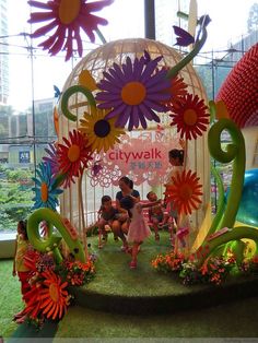 people are sitting in front of a fake flower display