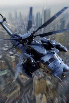 a large helicopter flying through the air over a city